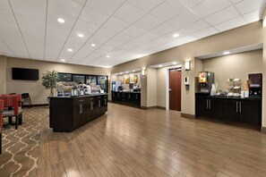 A spacious hotel lobby with a reception desk, seating area, and a buffet setup. - Comfort Suites Nashville near Percy Priest Lake (Nashville)
