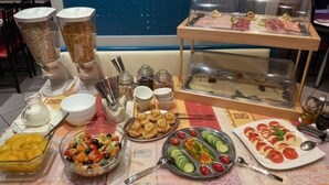 A buffet table with various food items including fruits, vegetables, and meats. - Hotel Wasserburg (Munich)