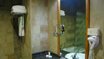 A bathroom with a sink, mirror, and towel rack.