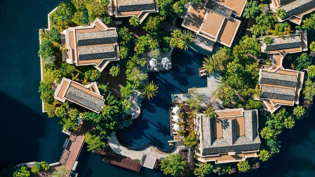 An aerial view of a resort with multiple buildings, a central pool, and surrounding greenery. - One&Only Cape Town (Cape Town)
