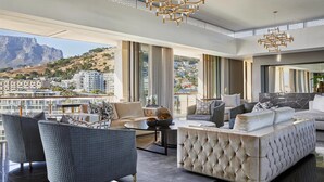 A modern living room with a view of a cityscape and mountains. - One&Only Cape Town (Cape Town)