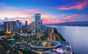 A modern urban skyline with high-rise buildings, a waterfront promenade, and a circular traffic interchange. - Shangri-La Wenzhou (Wenzhou)
