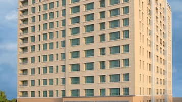 Experience the Somerset's sleek, contemporary design, featuring a symmetrical facade with spacious balconies and lush green surroundings.
