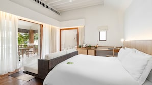 A spacious bedroom with a large bed, a wooden headboard, a bedside table, and a view of an outdoor patio area. - SALA Samui Choengmon Beach (Koh Samui)