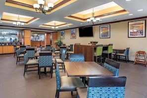 Enjoy meals in a spacious dining area with comfortable seating and a central island.