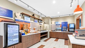 A modern breakfast area with labeled sections for yogurt, eggs, milk, fruit, and cereal. - Holiday Inn Express Hotel & Suites Pauls Valley by IHG (Pauls Valley)