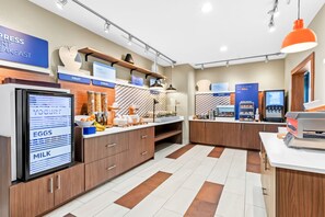 A modern breakfast area with labeled sections for yogurt, eggs, milk, fruit, and cereal. - Holiday Inn Express Hotel & Suites Pauls Valley by IHG (Pauls Valley)
