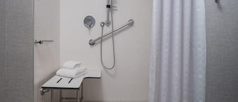 A modern bathroom with a shower, a toilet, and a sink.