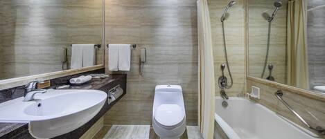 Un baño moderno con un lavamanos grande, inodoro y bañera.