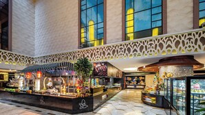 A spacious lobby with a central display area, large windows, and a decorative ceiling. - Crowne Plaza Foshan by IHG (Foshan)