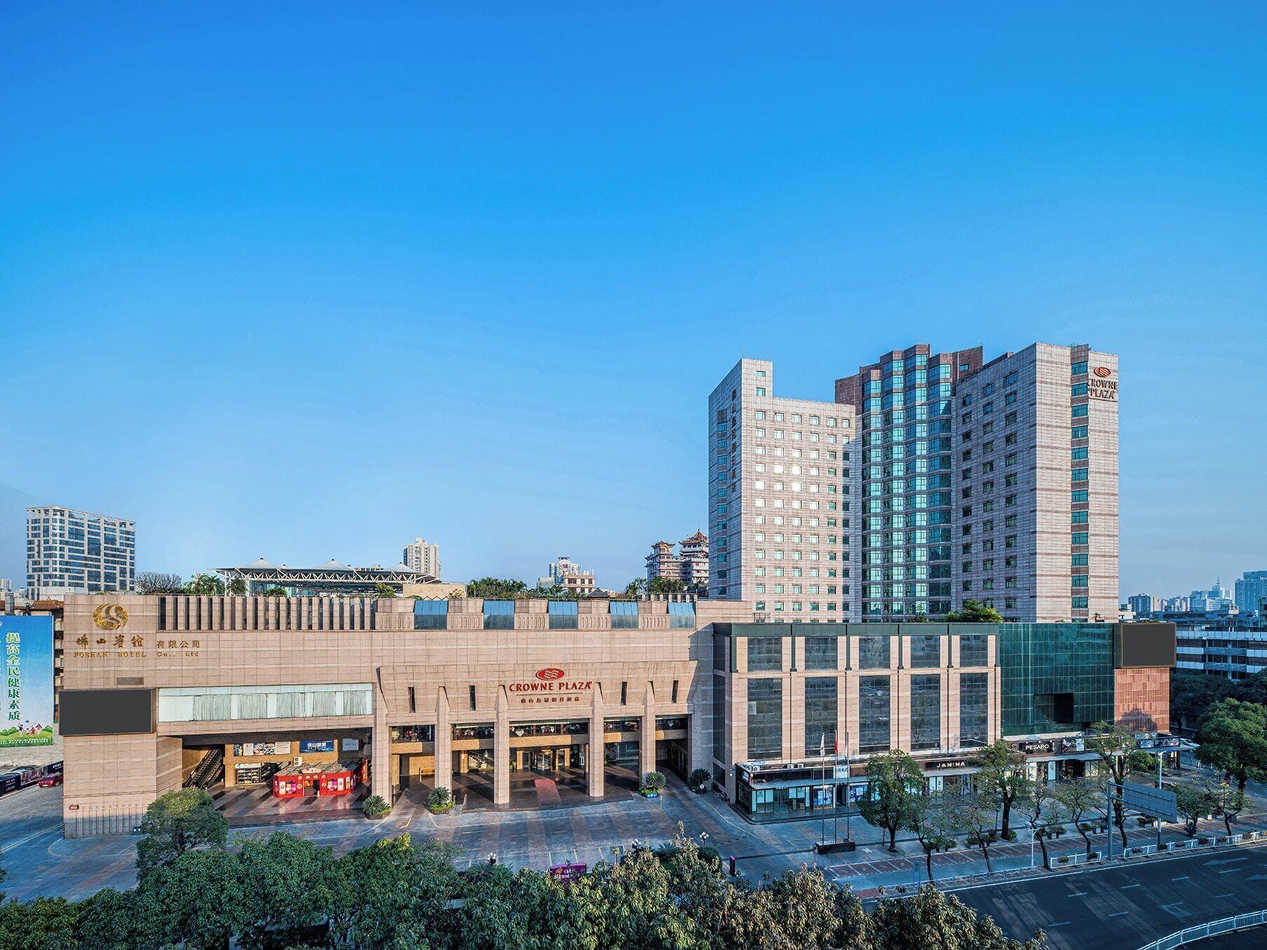 A hotel with a modern facade, multiple floors, and a prominent entrance.