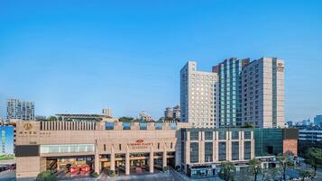 A hotel with a modern facade, multiple floors, and a prominent entrance.