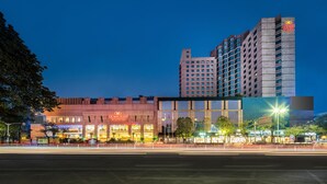 A hotel with a modern facade, multiple floors, and a prominent sign for Crowne Plaza. - Crowne Plaza Foshan by IHG (Foshan)