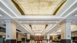 A spacious lobby with high ceilings, large chandeliers, and marble flooring. - Crowne Plaza Foshan by IHG (Foshan)