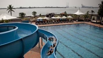Enjoy a fun-filled day at the adjacent water park with a large water slide and pool area featuring lounge chairs and umbrellas.