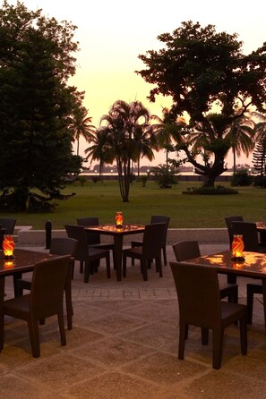 Guests can dine al fresco amidst lush greenery and scenic views of the water.