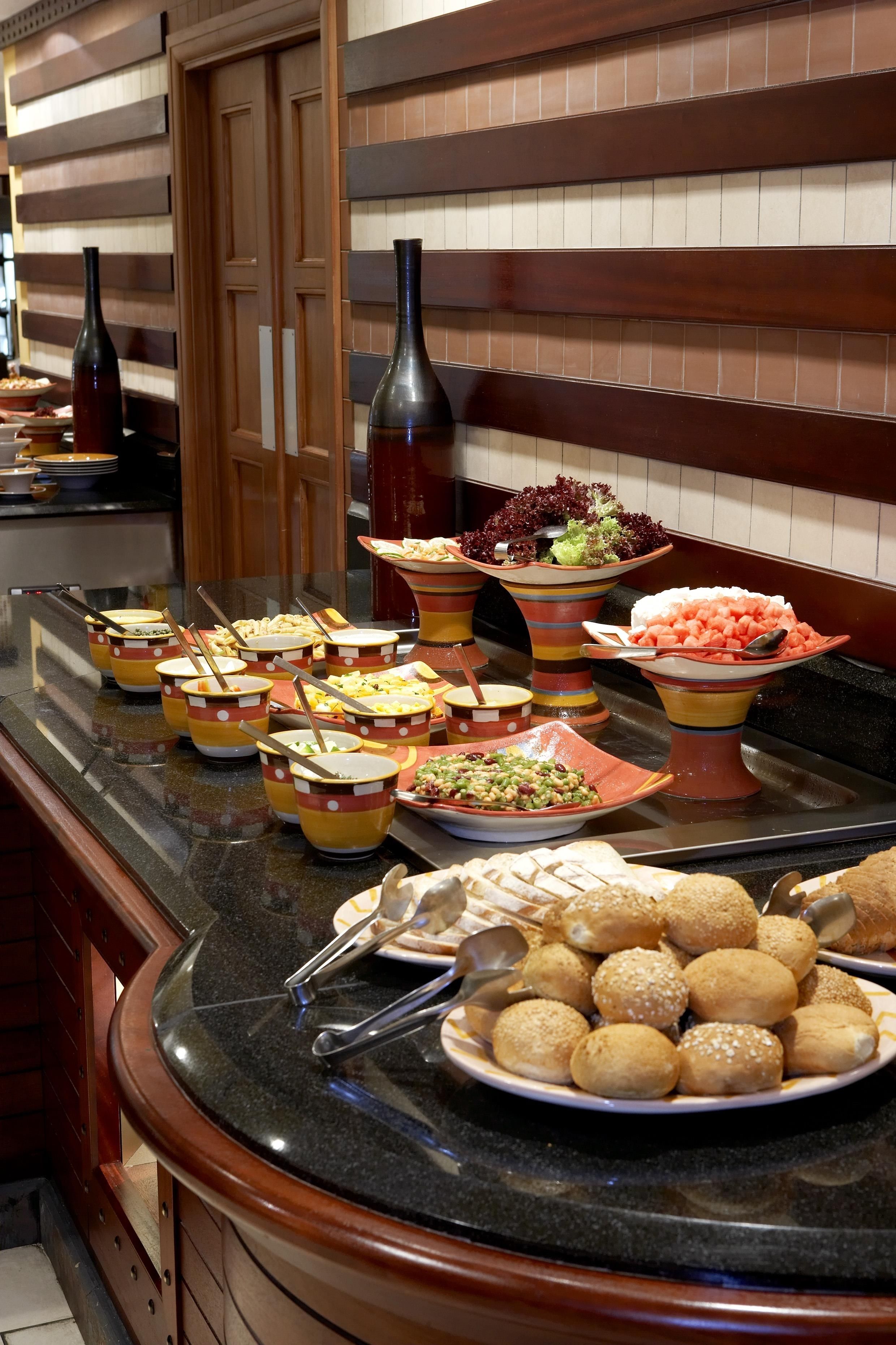 A buffet with various dishes and drinks.