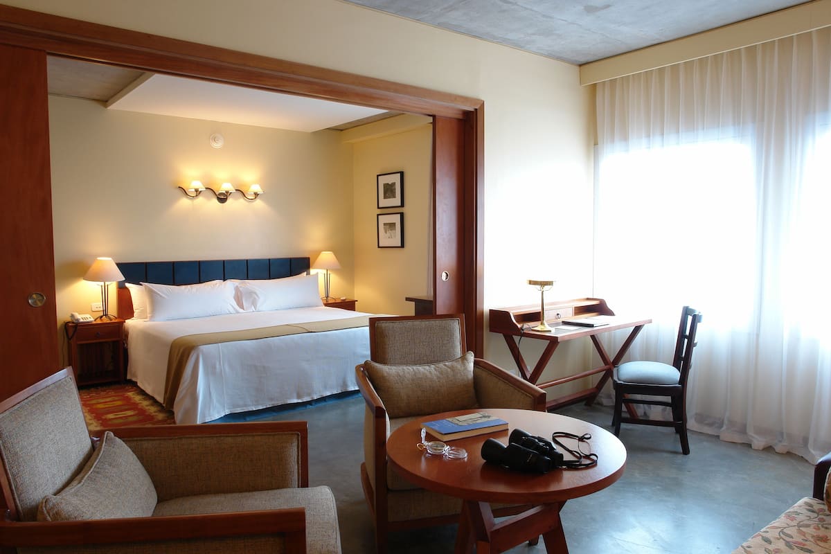 junior suite, 1 king bed, sea view | 1 bedroom, minibar, in-room safe, desk