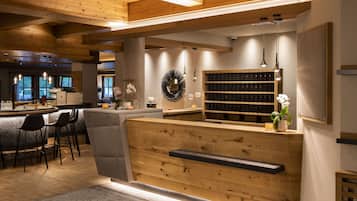 A modern interior with wooden accents, a bar area, and a seating arrangement.