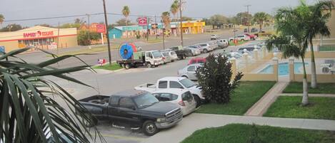 A parking lot with several cars, a truck, and a building with a sign that reads "Family Dollar".