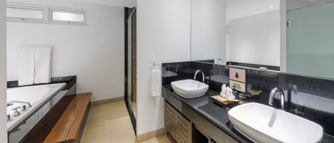 A modern bathroom with two sinks, a large mirror, and a wooden bench.