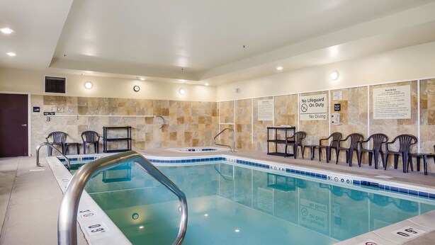An indoor swimming pool with clear water, tiled walls, and a no lifeguard on duty sign. - Hampton Inn Galax (Galax)