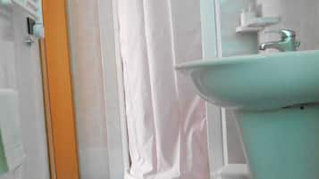 Ein Badezimmer mit einer weißen Badewanne, einem weißen Waschbecken und einem blauen Boden.