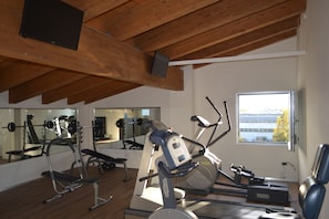 Work out in style with a well-equipped gym featuring treadmills, a stationary bike, and free weights.