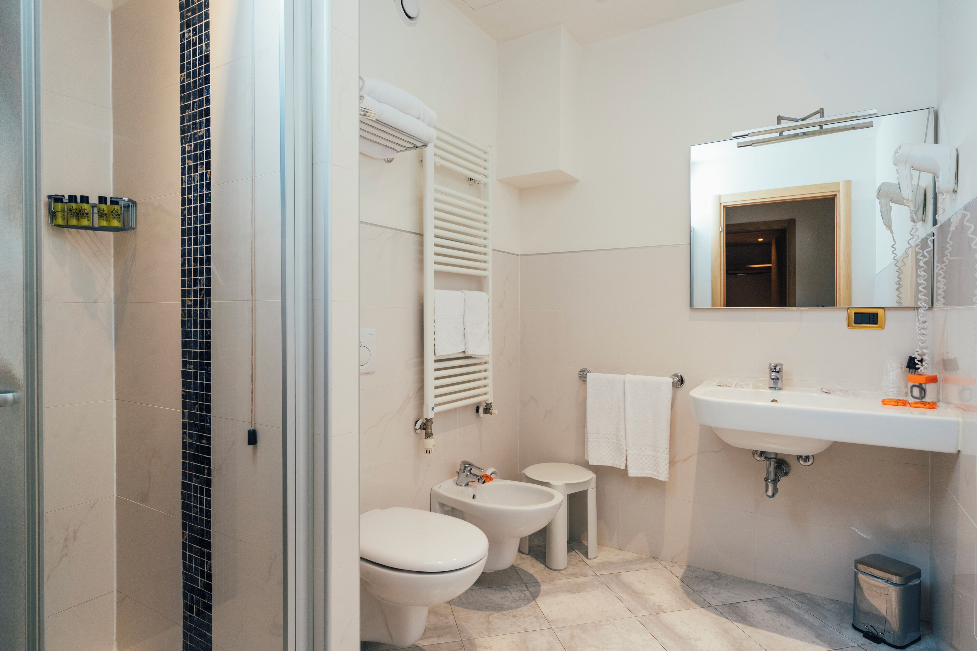 junior suite | bathroom | hair dryer, bidet, towels