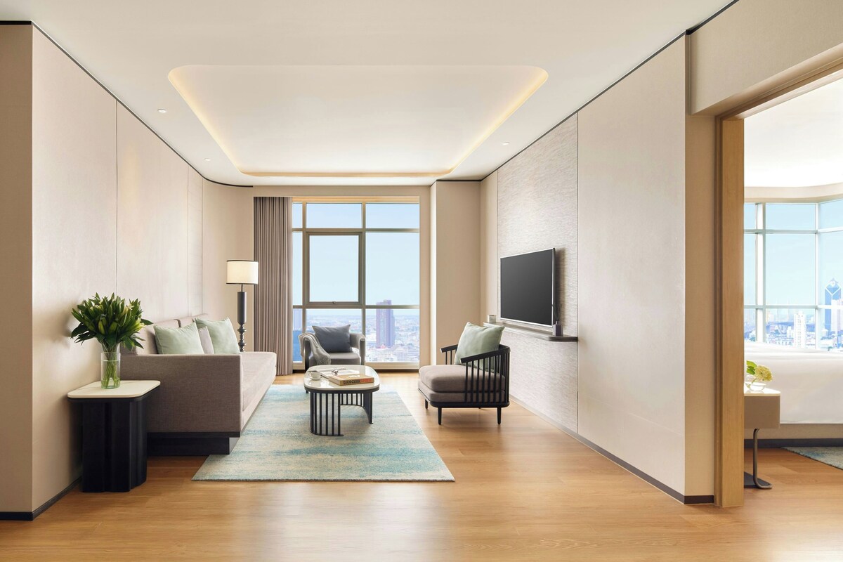 Deluxe Suite, 3 Bedrooms, City View | Living room | 55-inch LED TV with cable channels, TV, pay movies