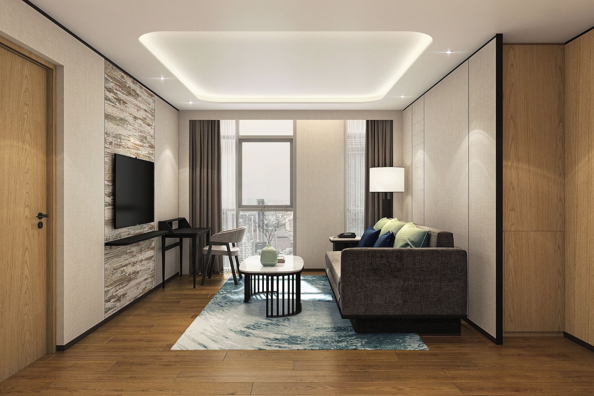 Executive Suite, 1 Bedroom | Living room | 55-inch LED TV with cable channels, TV, pay films