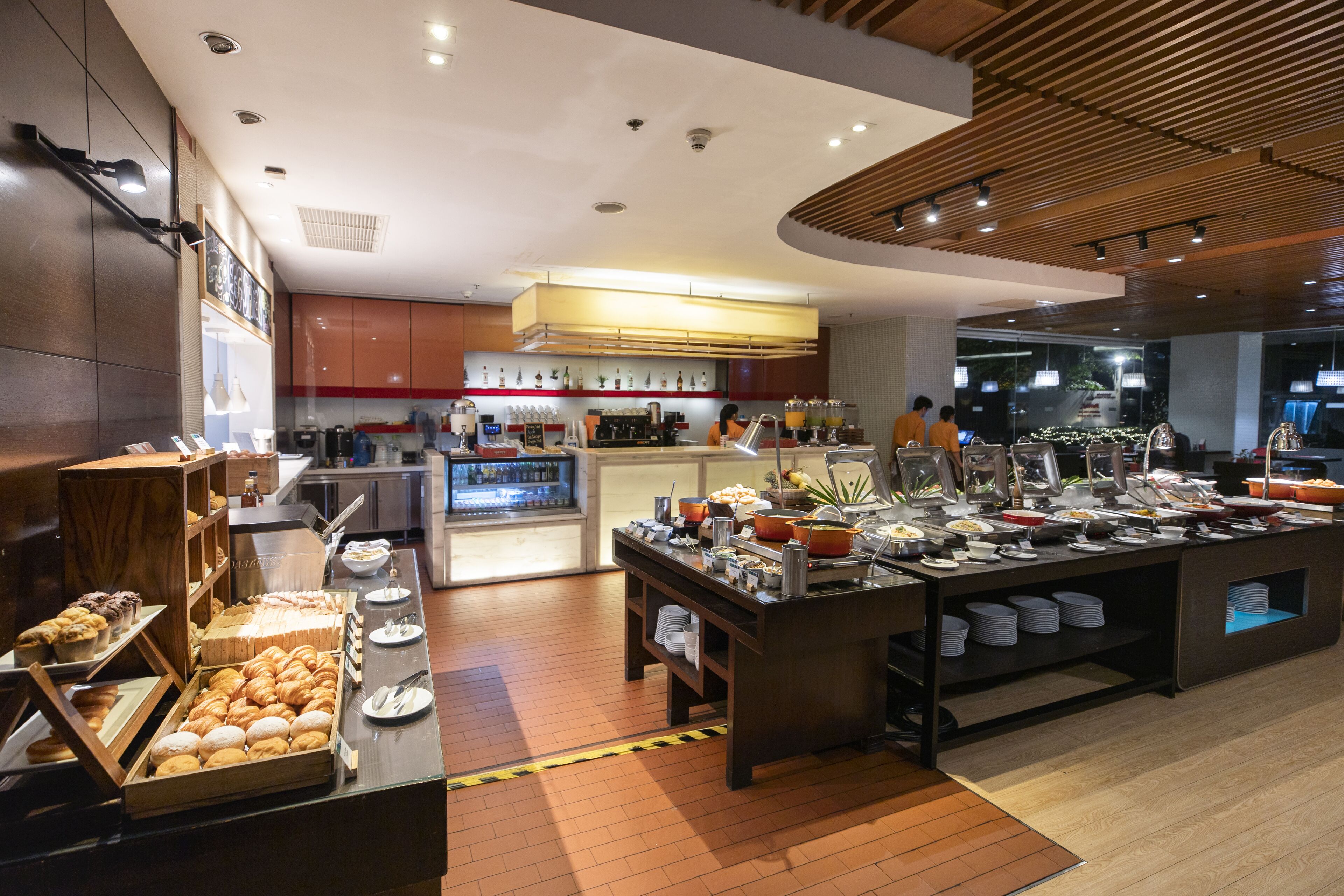 A buffet setup with various food items and a coffee station.