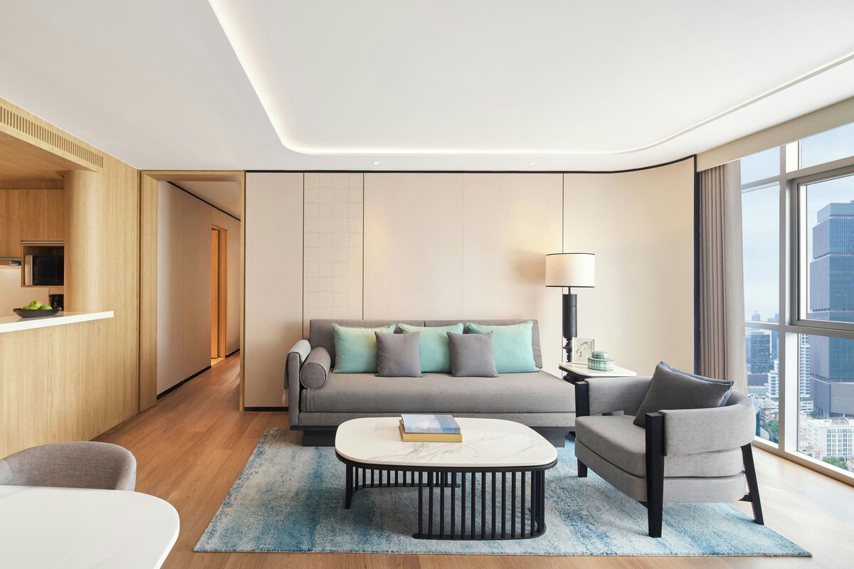 Deluxe Suite, 2 Bedrooms, City View | Living room | 55-inch LED TV with cable channels, TV, pay movies