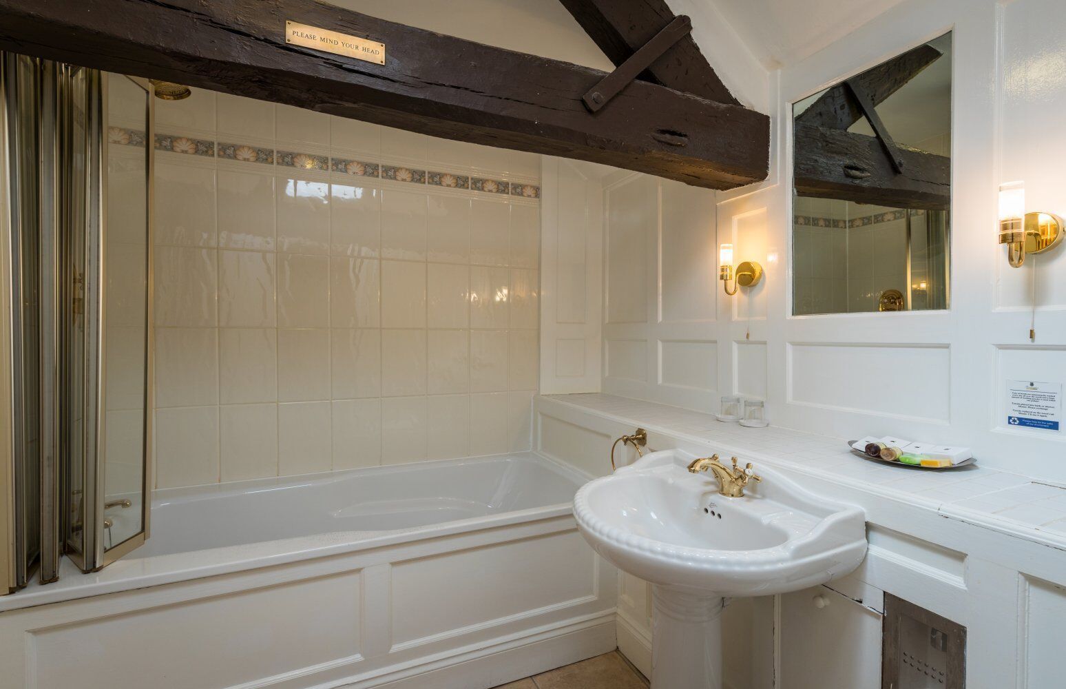 A bathroom with a bathtub, a sink, and a shower.
