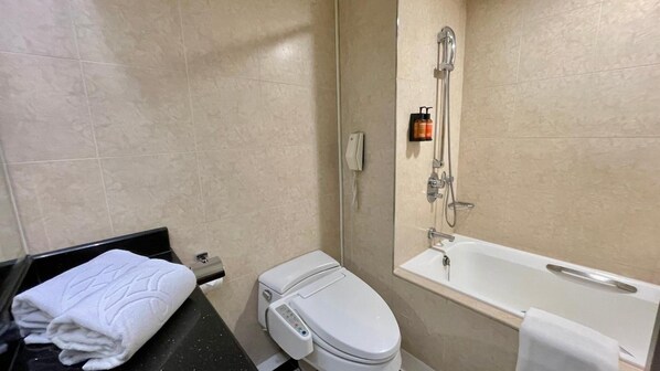 A modern bathroom with a toilet, a shower, and a bathtub.