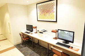 A hotel workspace with two computers, a printer, and a framed artwork on the wall. - Holiday Inn Express & Suites Napa American Canyon by IHG (American Canyon)