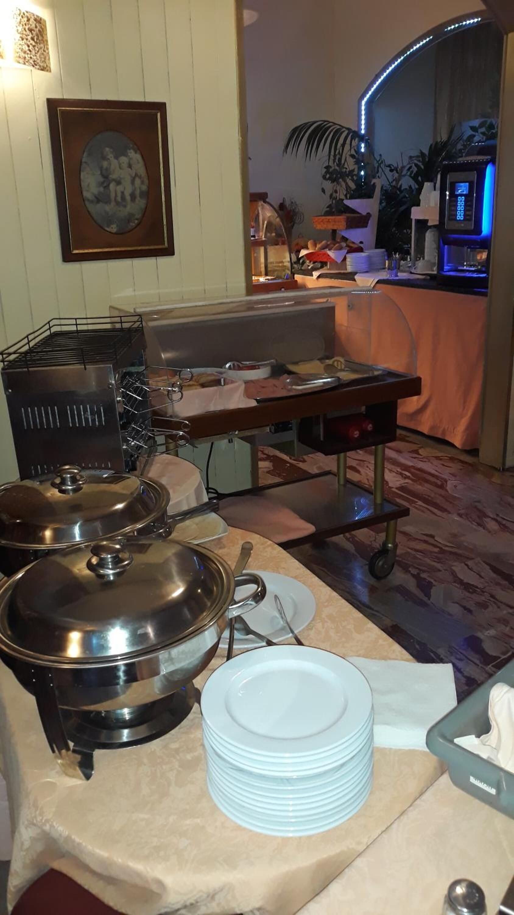 A buffet setup with various food containers and serving utensils.