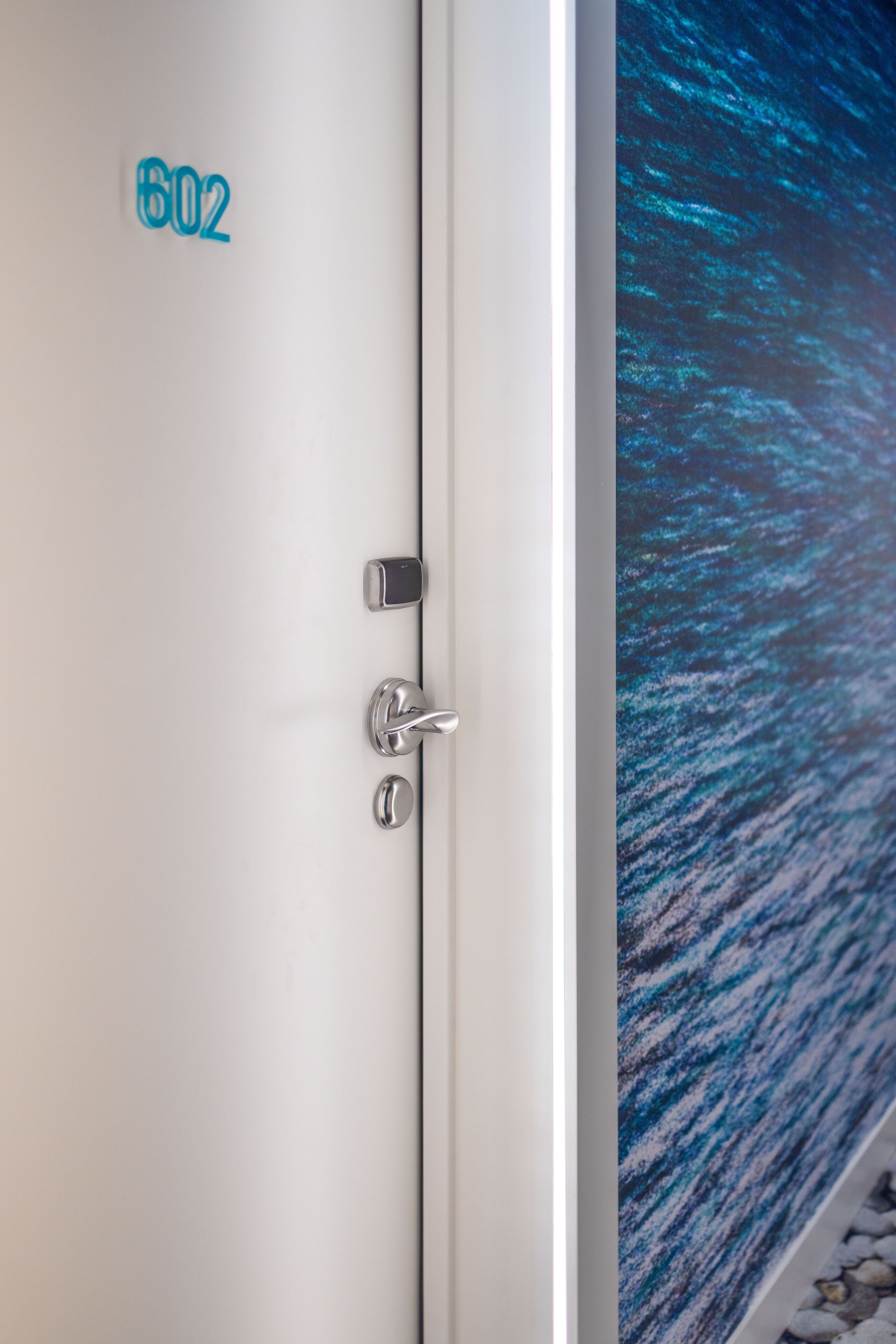 A door with the number 602, a digital lock, and a handle.