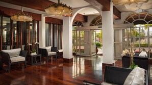 A spacious lobby with wooden flooring, comfortable seating, and large windows offering views of the outdoors. - S Hotel Kingston (Kingston)