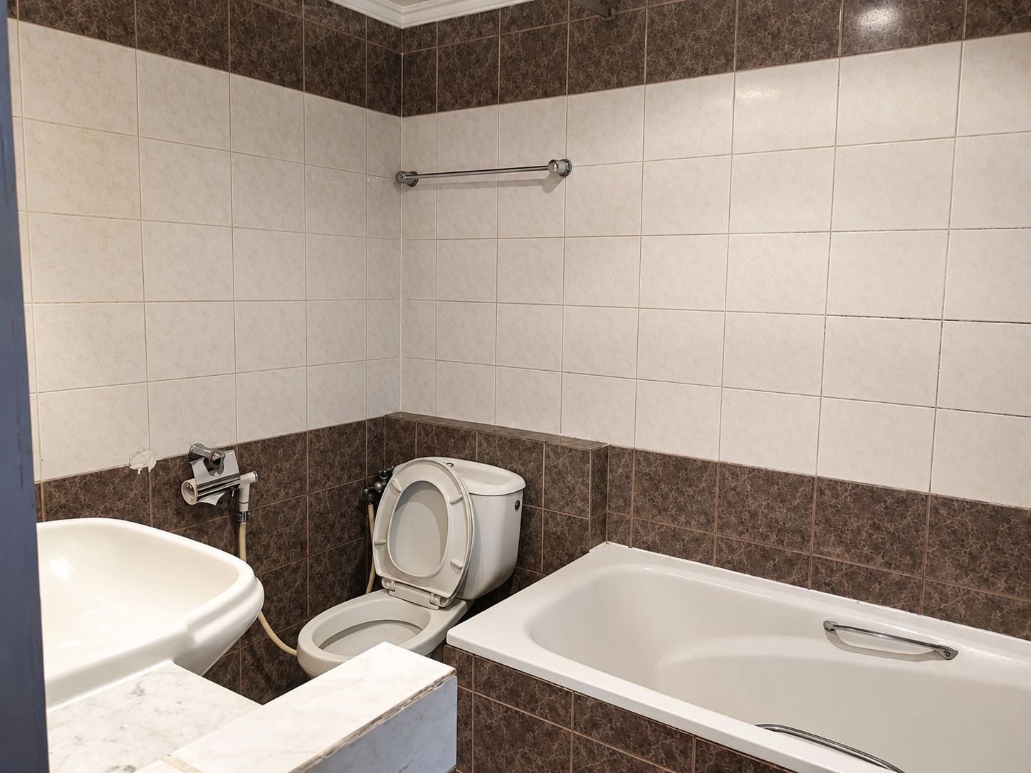 A bathroom with a toilet, bidet, and bathtub.