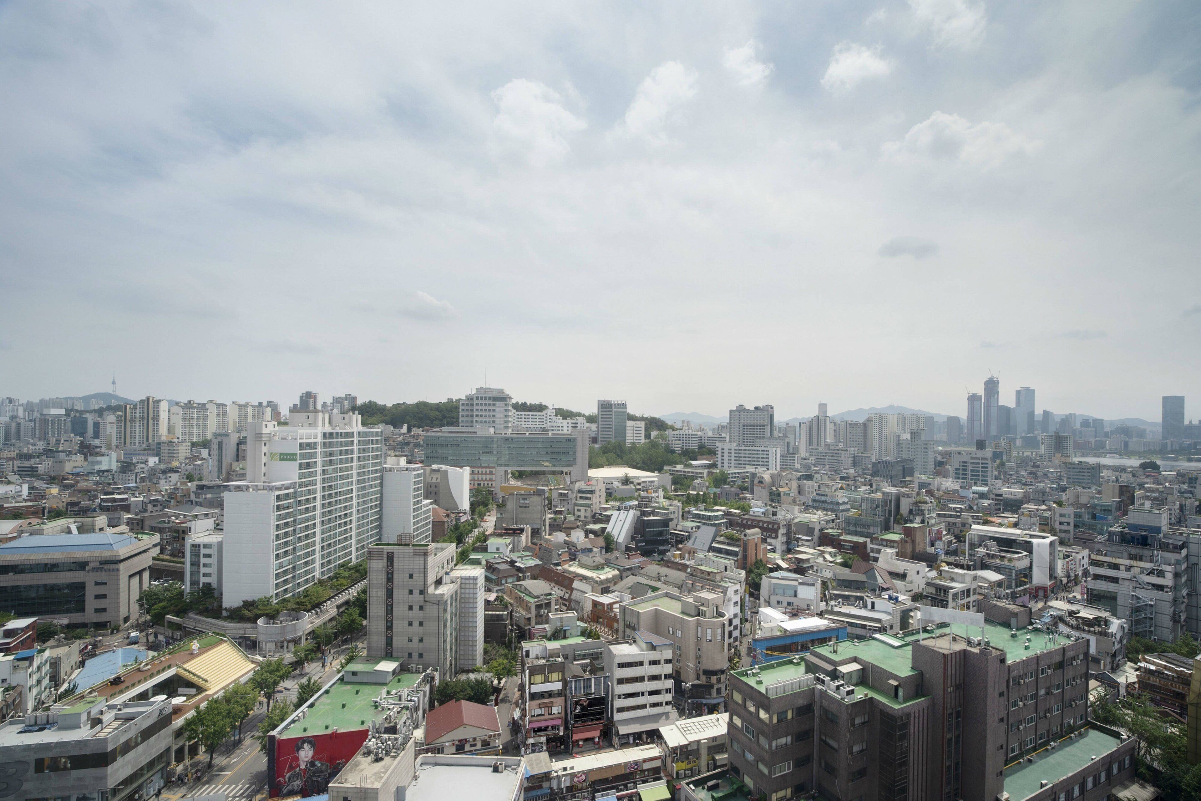 A cityscape with a variety of buildings, including high-rise and mid-rise structures.