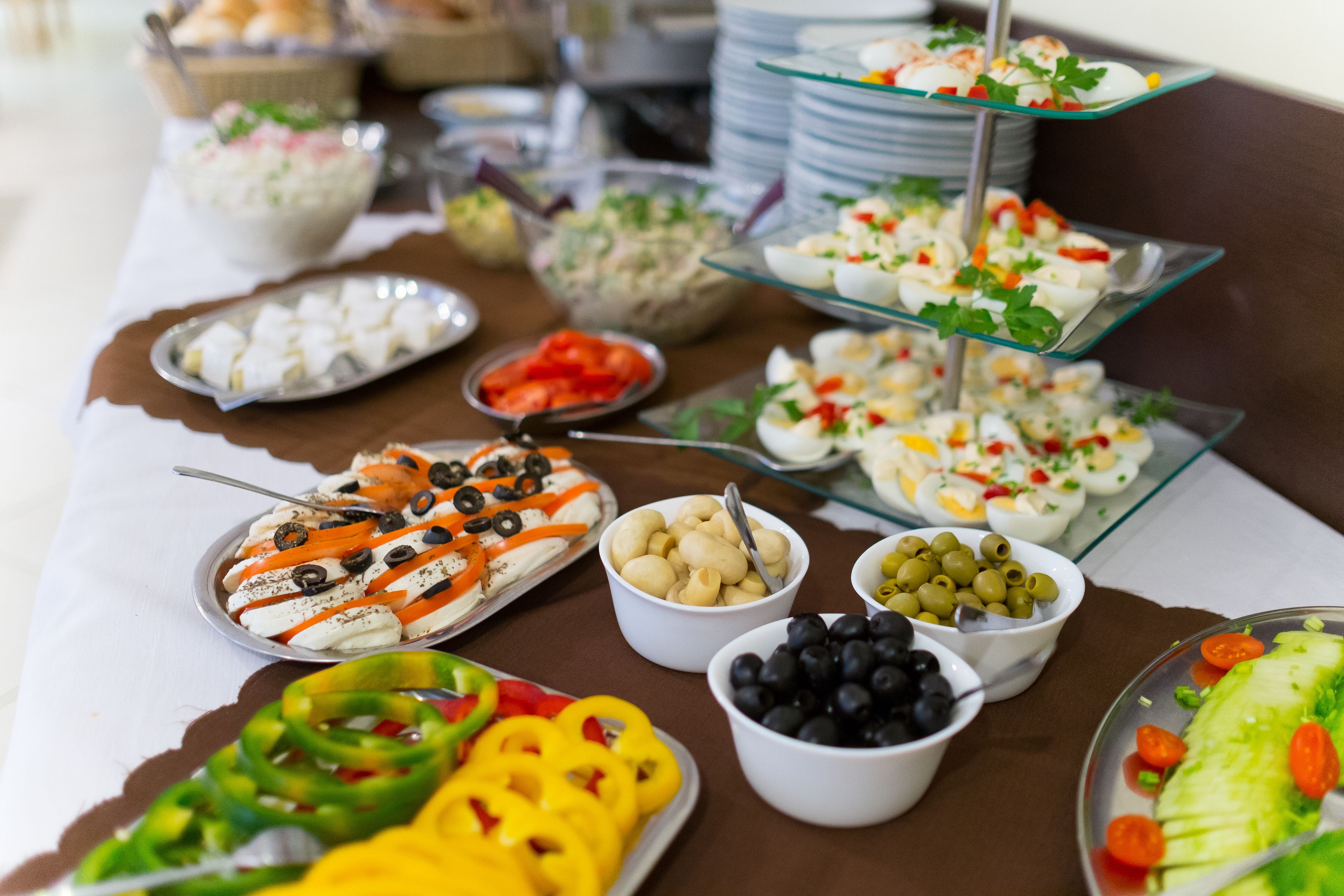 A buffet table with various food items including salads, fruits, and appetizers.