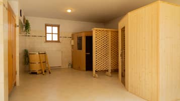 A spacious room with a wooden sauna, a window, and a radiator.