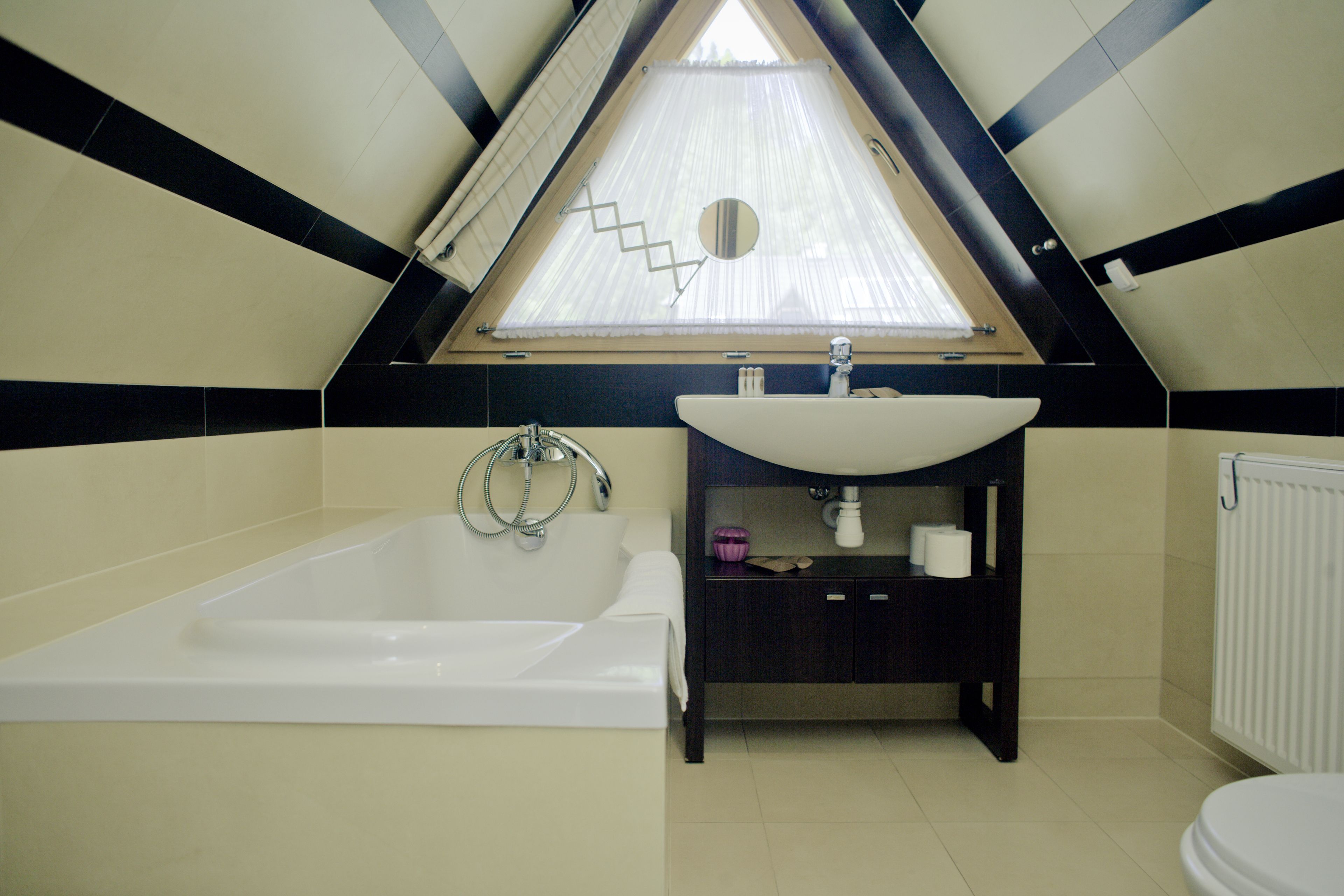 A modern bathroom with a freestanding bathtub, a vanity with a sink, and a toilet.