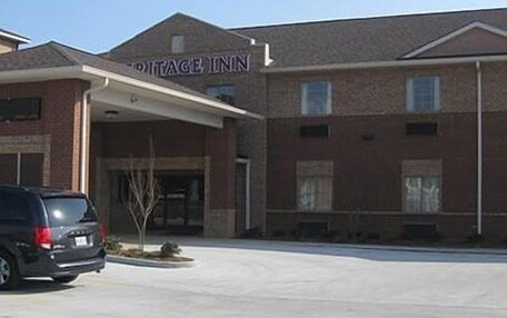 A brick building with a sign reading "VILLAGE INN".