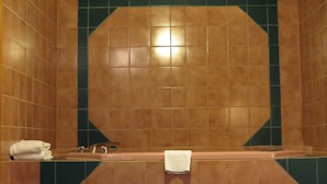 A bathroom with a bathtub, a towel rack, and a sink.