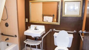 A bathroom with a bathtub, a sink, a toilet, and a mirror. - OYO Hotel Richburg SC I-77 (Richburg)