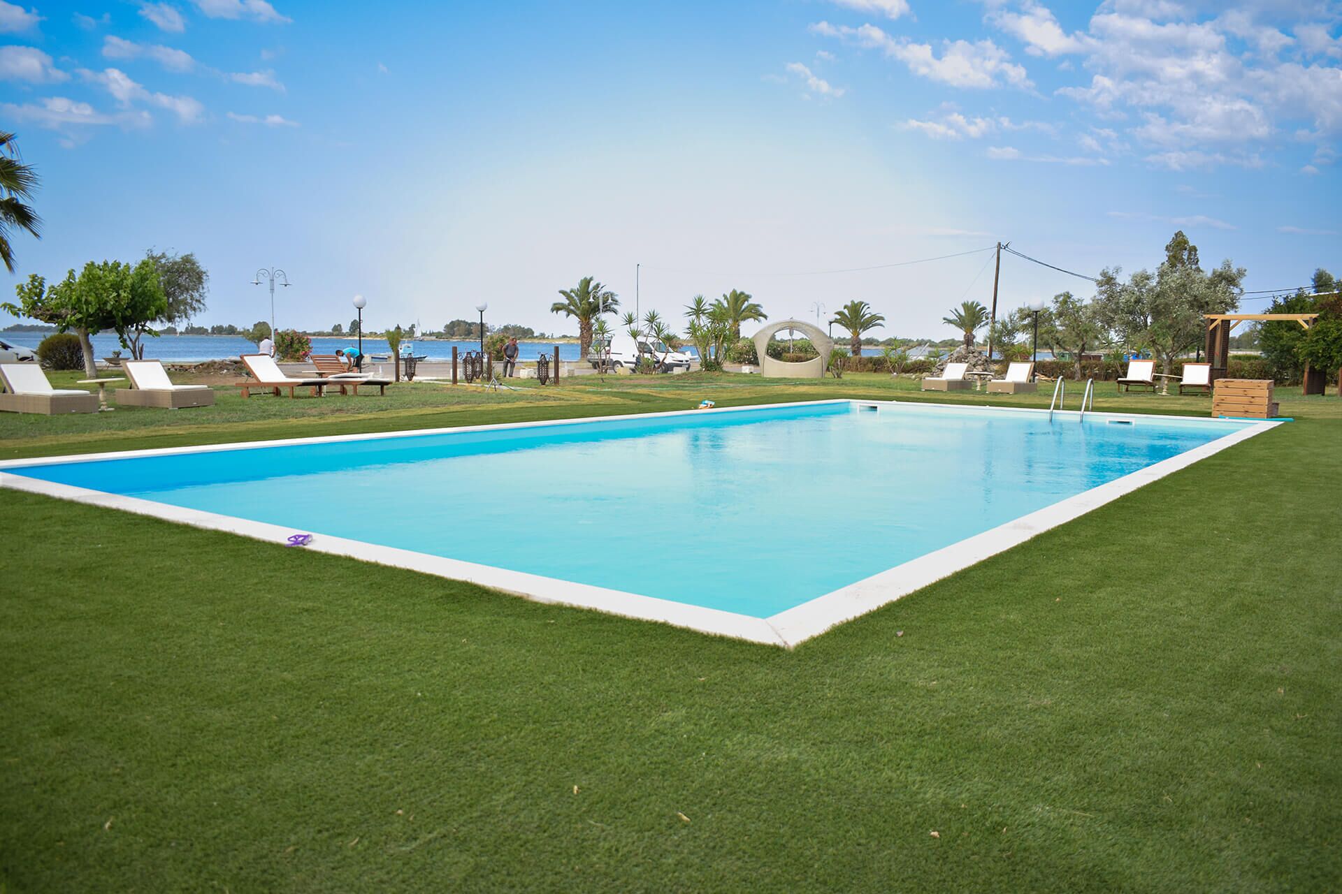 Seasonal outdoor pool, open 9:00 AM to 9:00 PM, pool umbrellas