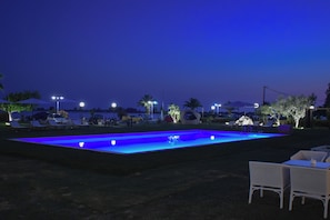 Seasonal outdoor pool, open 9:00 AM to 9:00 PM, pool umbrellas