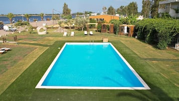 Seasonal outdoor pool, open 9:00 AM to 9:00 PM, pool umbrellas